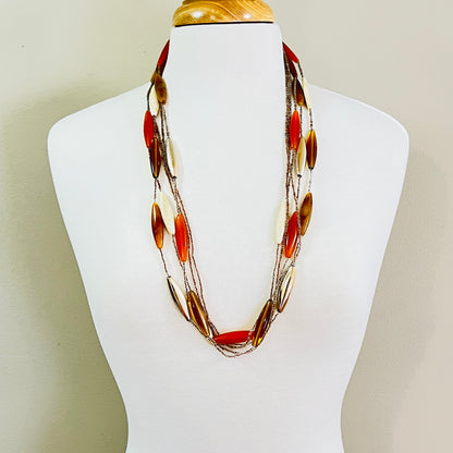 Long 1970s lucite necklace displayed on mannequin with layered strands