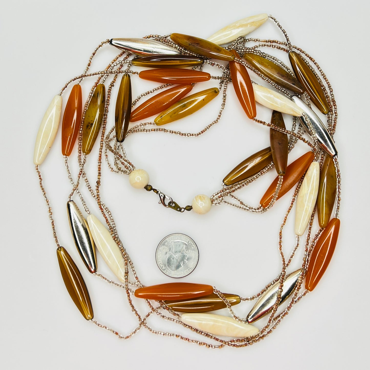 Close-up of lucite elongated beads and glass seed bead strands