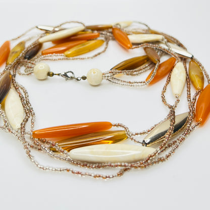 Close-up of lucite elongated beads and glass seed bead strands