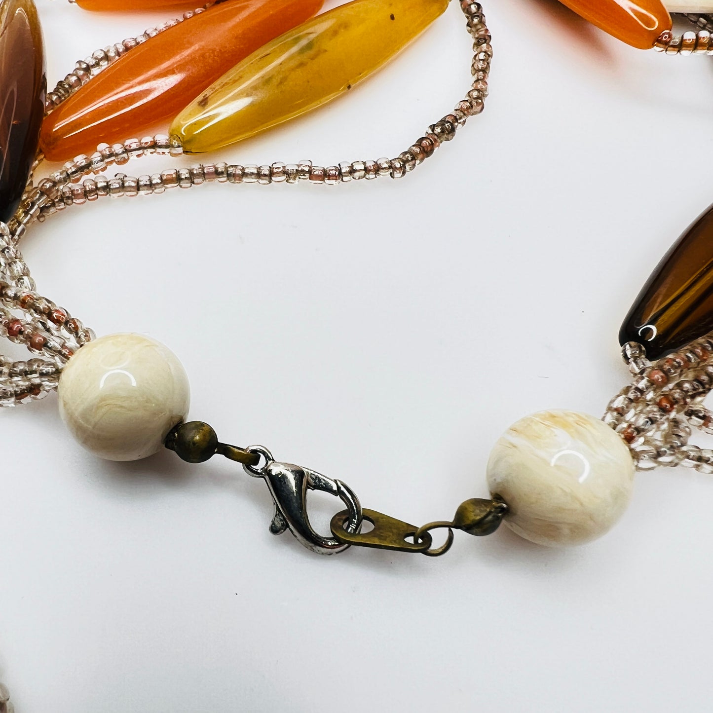 Detail of lobster clasp and bead ends on vintage necklace