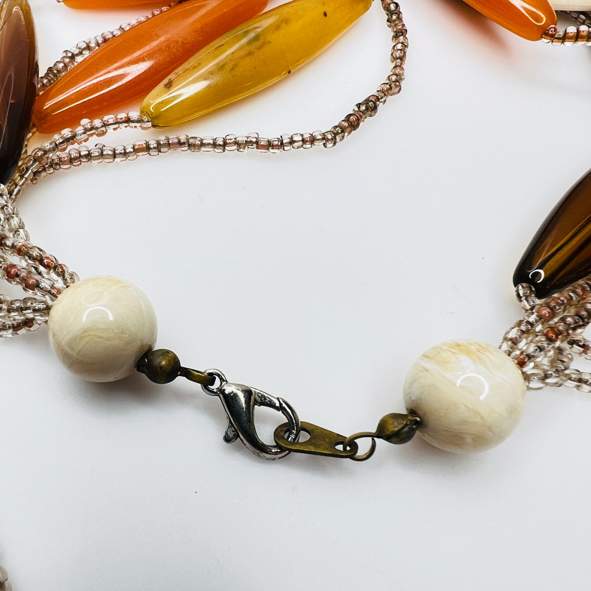 Detail of lobster clasp and bead ends on vintage necklace