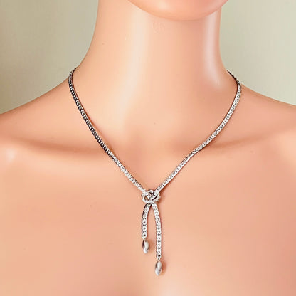 Silver textured Y necklace worn on mannequin with knot detail