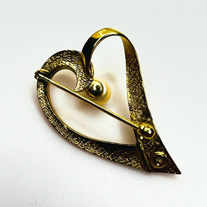 Reverse of vintage modernist heart brooch showing pin clasp, textured gold vermeil backing and sterling silver hallmark.