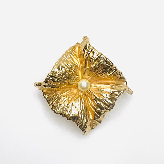Vintage 1980s Napier gold-tone sculptural brooch with crumpled foil-inspired textured design and central ivory faux pearl.