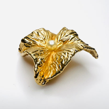 Angled side view of vintage Napier brooch showing deeply sculpted gold-tone folds, dimensional construction, and faux pearl center.
