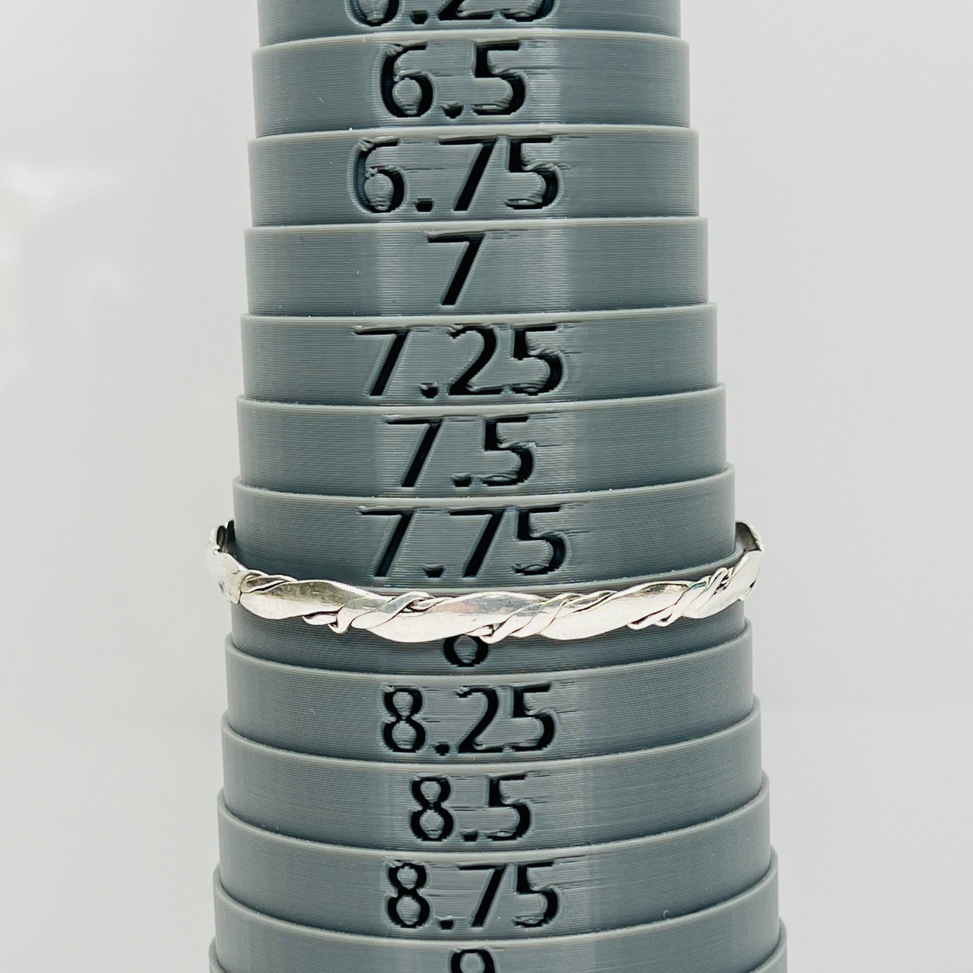 Vintage silver bangle bracelet shown with sizing mandrel