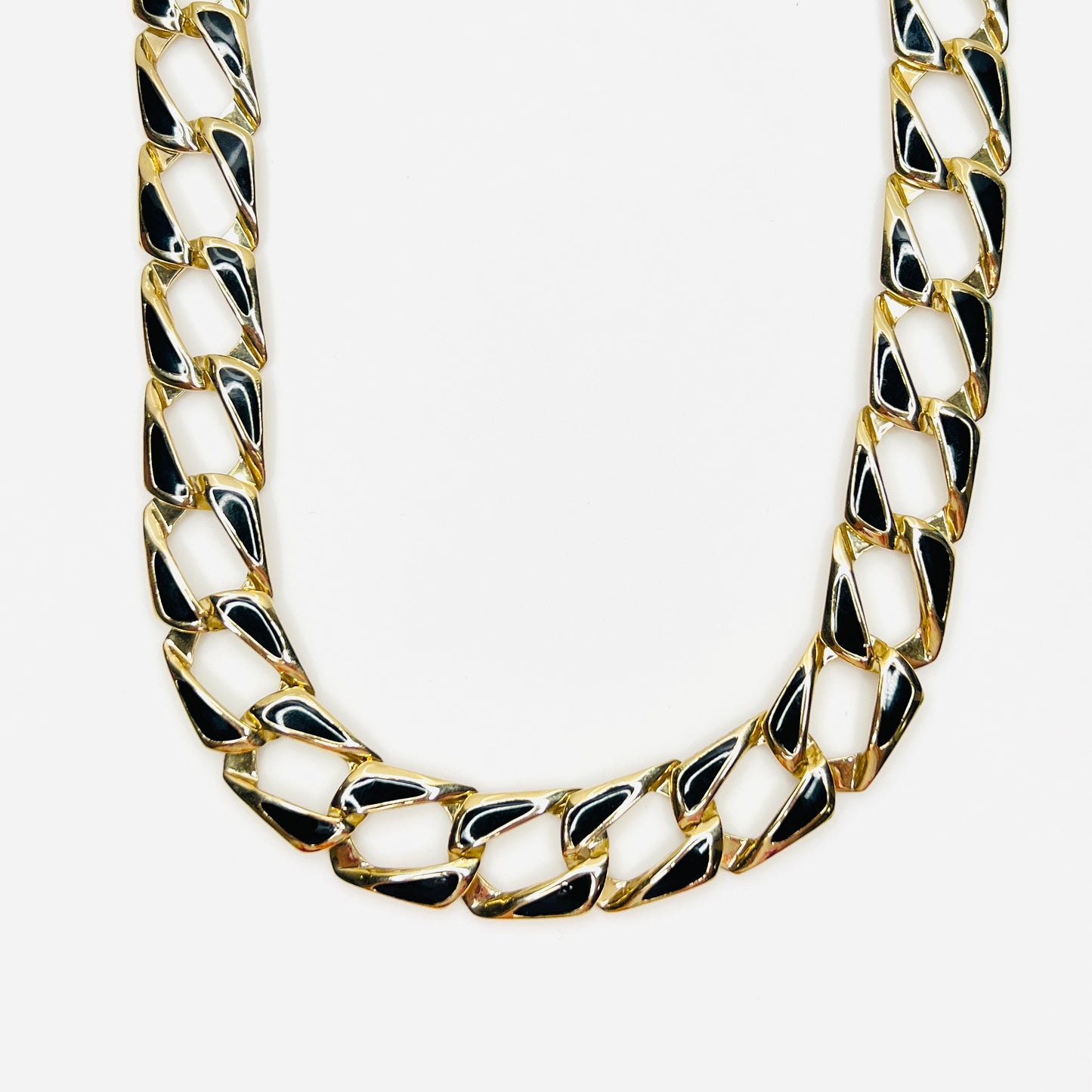 Vintage 1980s gold tone link necklace with glossy black enamel accents.