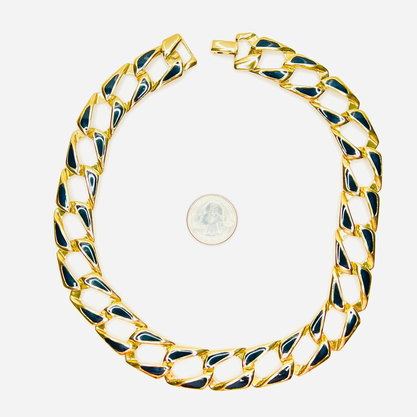 1980s gold tone black enamel statement link necklace shown beside quarter for scale.