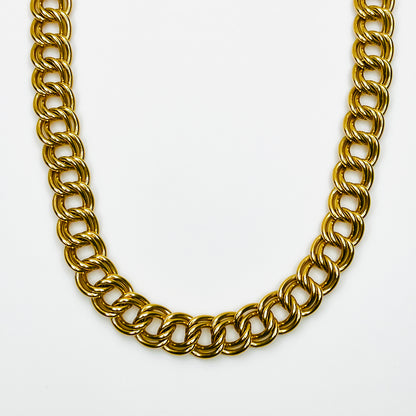 Close-up of vintage 1980s chunky gold-tone necklace featuring polished, dimensional double-link chain construction.