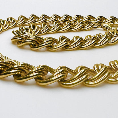 Close-up of vintage chunky gold-tone necklace showing polished, dimensional double links and substantial chain construction.