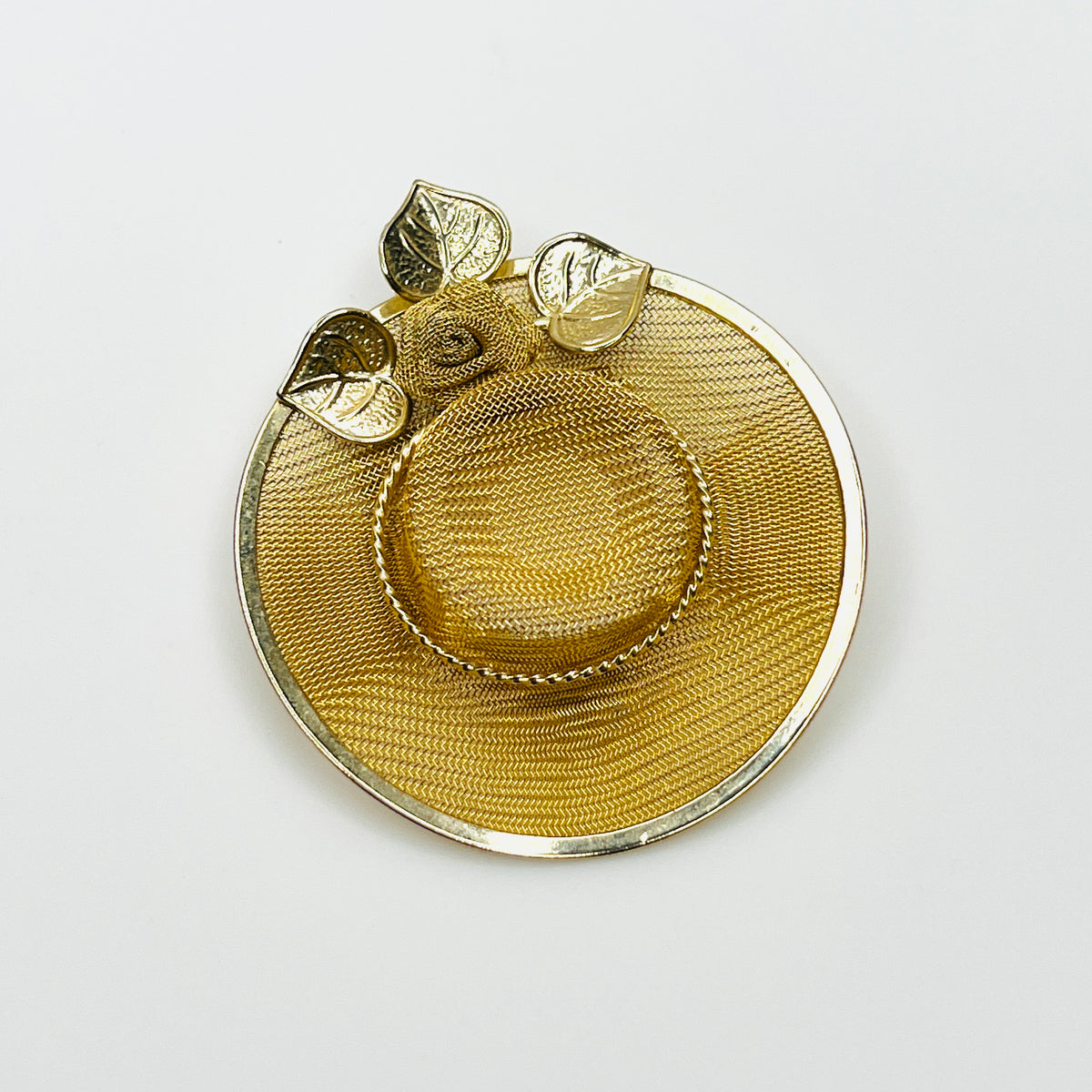 Vintage 1980s gold-tone wide-brimmed hat brooch with woven metal mesh, decorative rose and three leaves