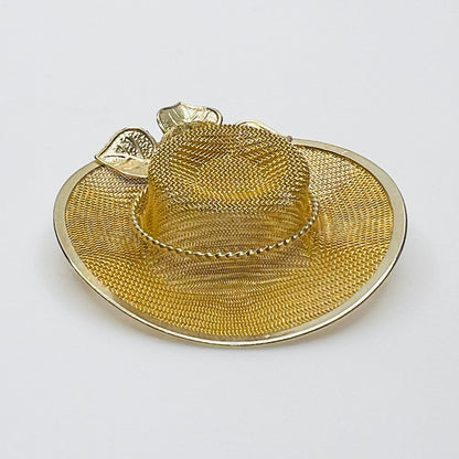 Side view of vintage gold-tone mesh hat pin showing dimensional crown, wide brim and rose embellishment