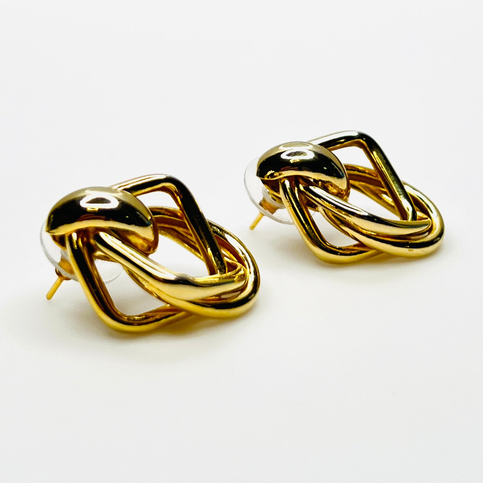 Side view of 1980s gold tone stationary door knocker earrings