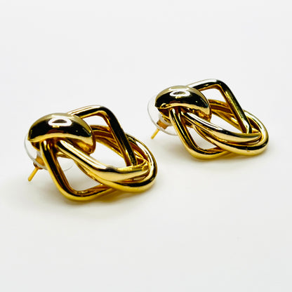 Side view of 1980s gold tone stationary door knocker earrings