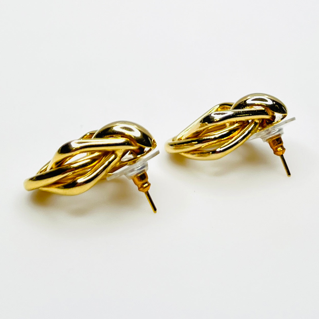 Side view of 1980s gold tone stationary door knocker earrings