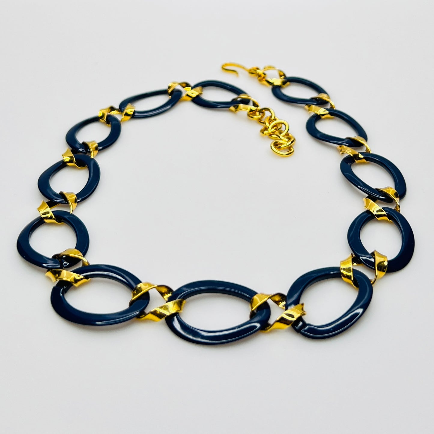 Monet navy blue enamel chain necklace with gold links flat lay