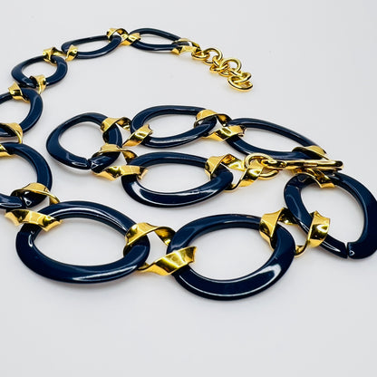 Close-up of navy enamel oval links with gold connectors