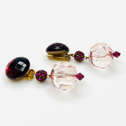 side view of vintage 1980s acrylic clip-on earrings with faceted pink beads and gold-tone hardware.