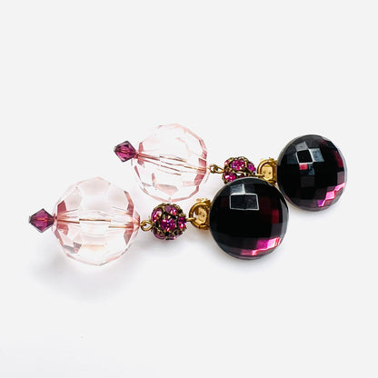 side view of vintage 1980s acrylic clip-on earrings with faceted pink beads and gold-tone hardware.