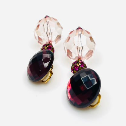 side view of vintage 1980s acrylic clip-on earrings with faceted pink beads and gold-tone hardware.