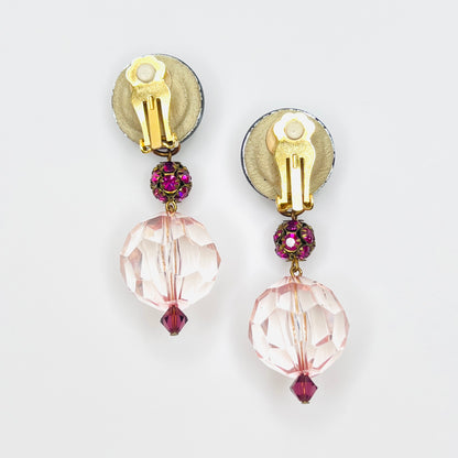 Back view of vintage clip-on earrings with gold-tone clips, suede-backed acrylic tops, and pink faceted drops.