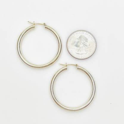 Sterling silver hoop earrings stamped 925 Italy shown with quarter for scale