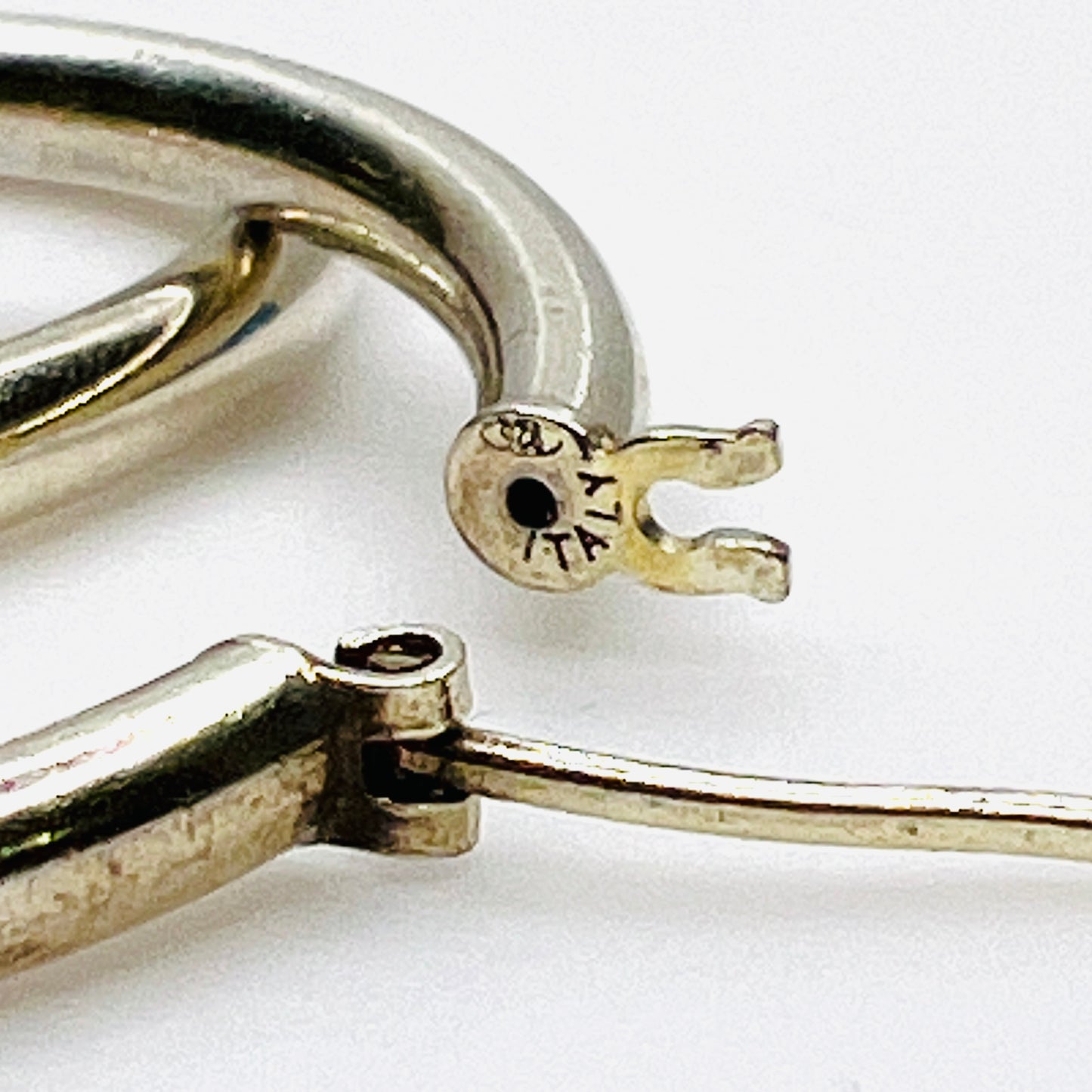 Close-up of 925 Italy hallmark on vintage sterling silver hoop earrings