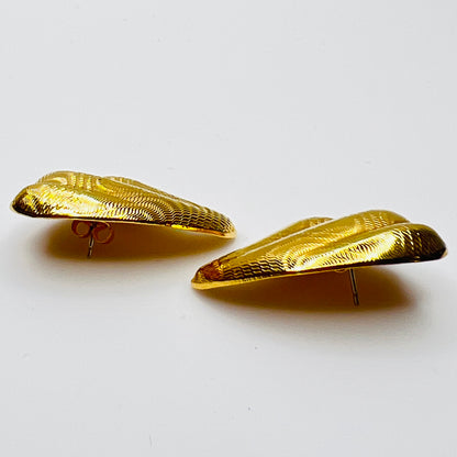 side view of vintage 1980s gold tone pierced statement earrings