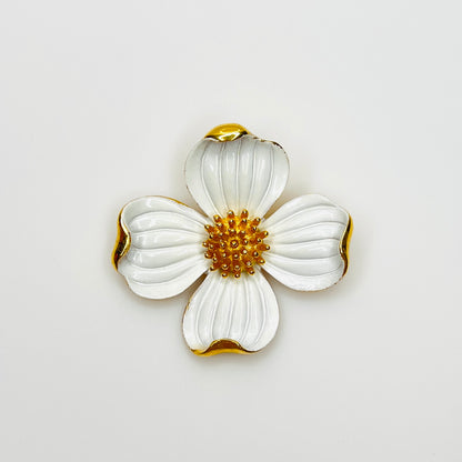 Vintage Crown Trifari white enamel dogwood flower brooch with gold-tone accents.