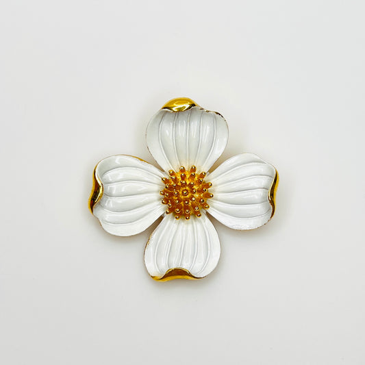 Vintage Crown Trifari white enamel dogwood flower brooch with gold-tone accents.