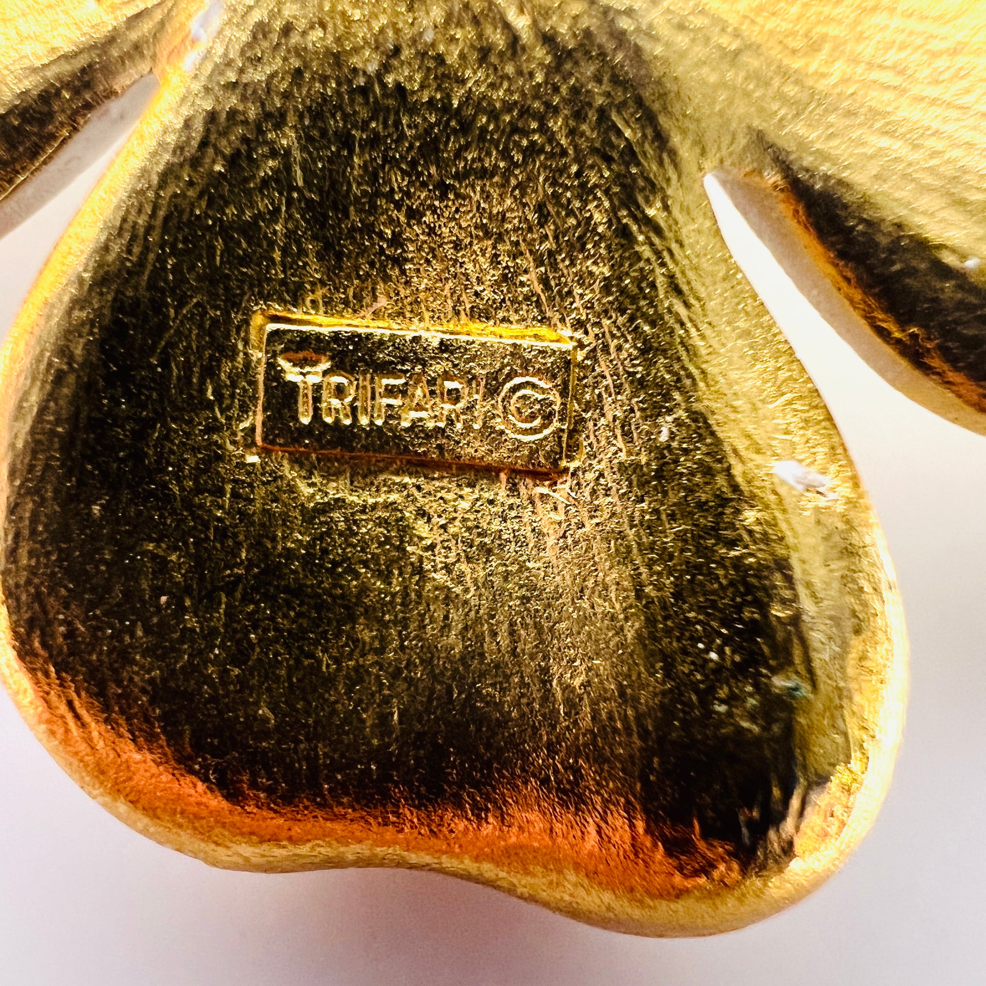 Close-up of Crown Trifari signature and copyright mark on reverse.