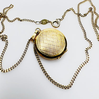 Back of vintage gold plated sterling silver locket with engraved geometric pattern