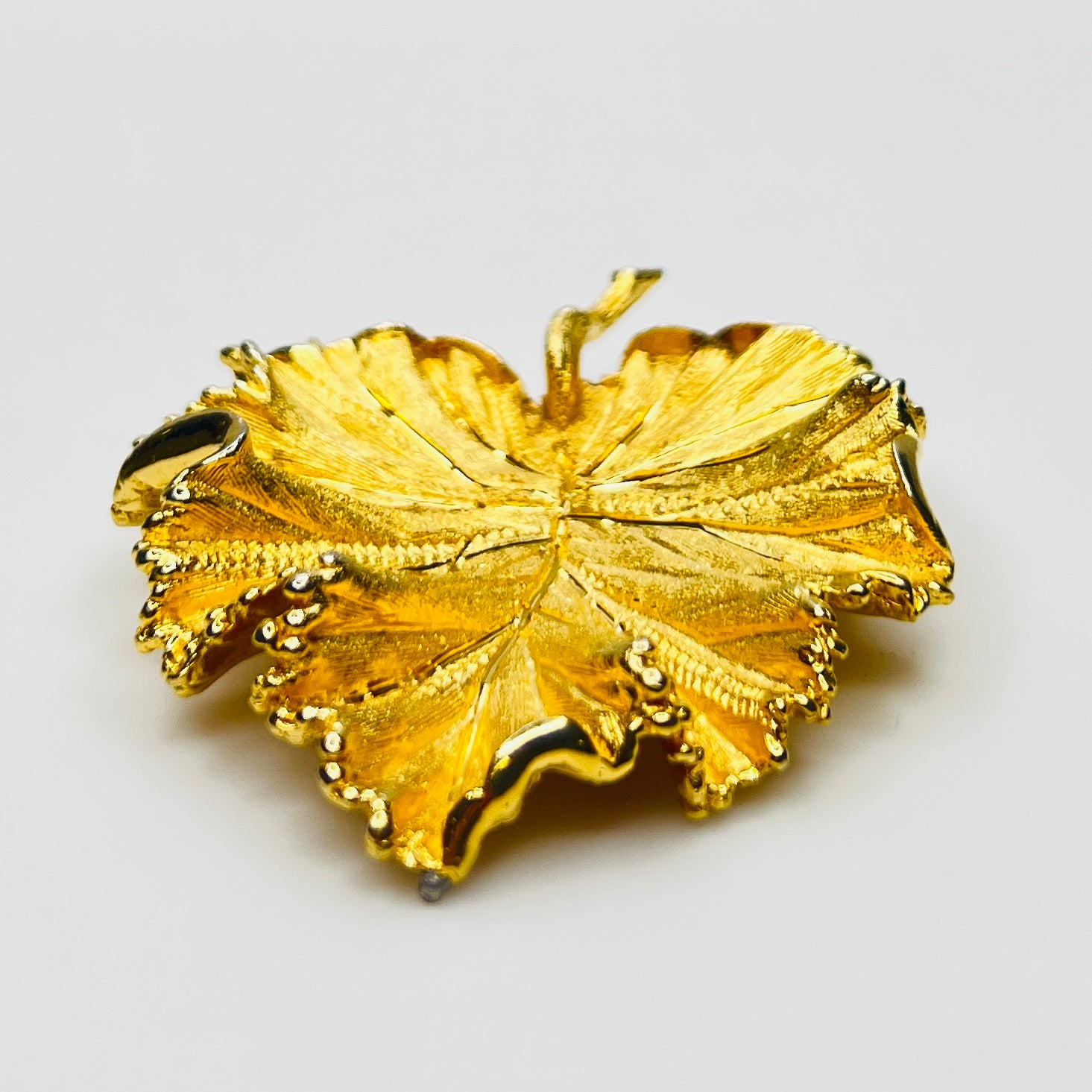 Side profile of textured gold leaf brooch