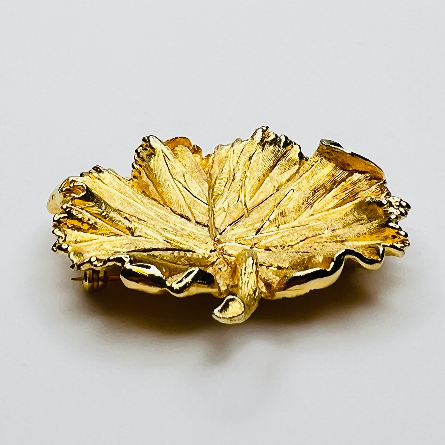 Side profile of textured gold leaf brooch