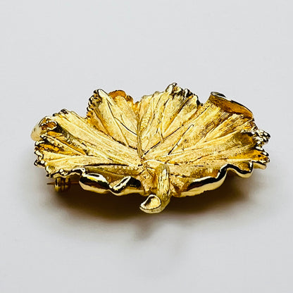 Side profile of textured gold leaf brooch