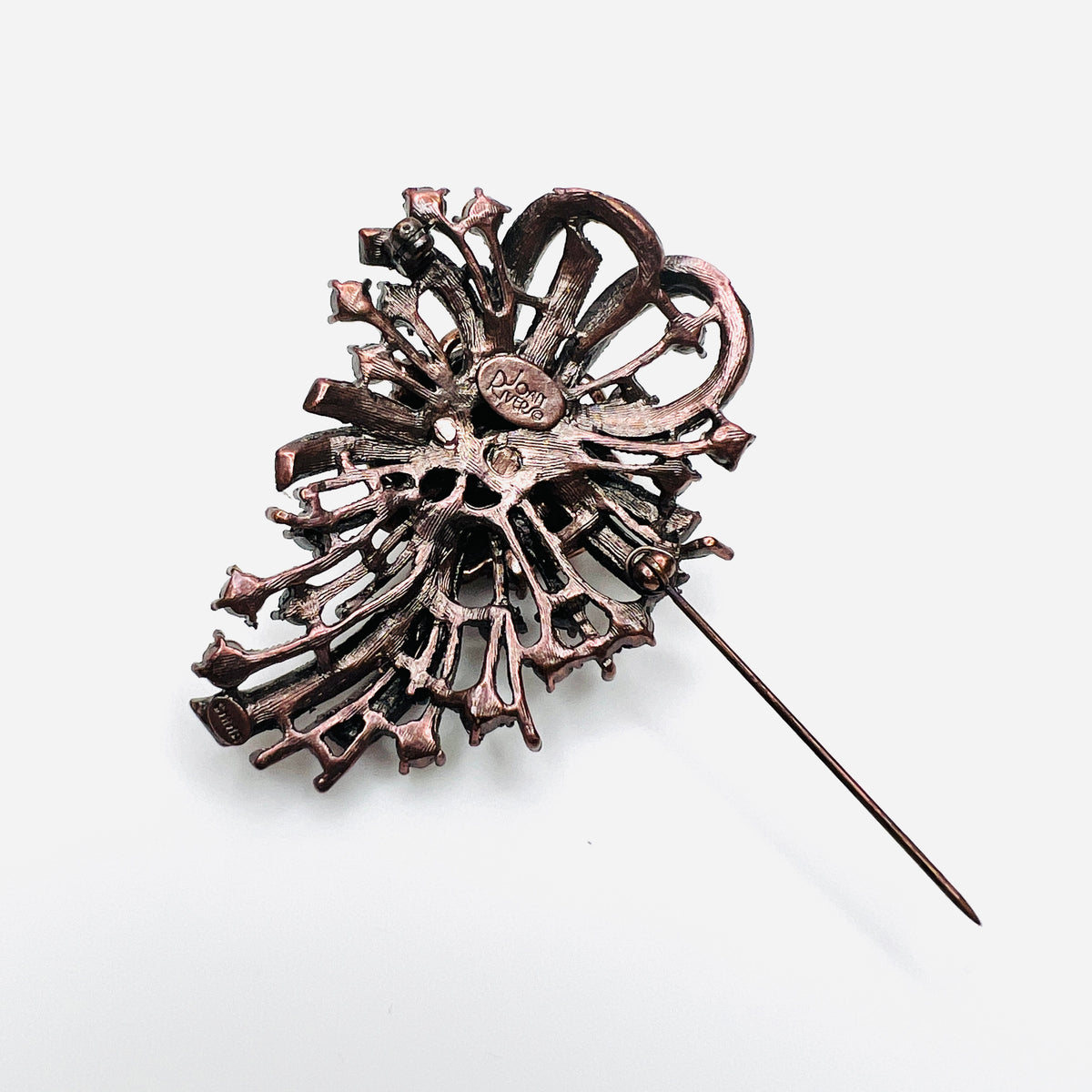 Reverse of vintage Joan Rivers rhinestone brooch showing signature and pin closure