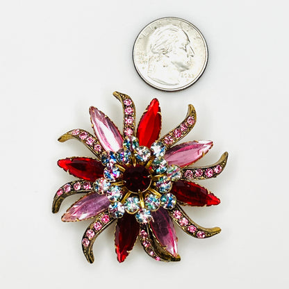 Oversized 1950s Selini rhinestone flower brooch beside a quarter showing its colorful 2 1/4-inch starburst design.