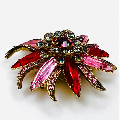 Side view of vintage Selro Selini floral brooch showing layered red, pink, and iridescent prong-set rhinestones.