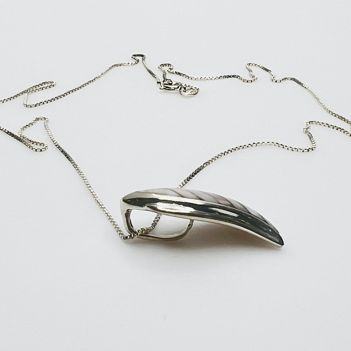 Side view sterling silver wave pendant mother of pearl detail