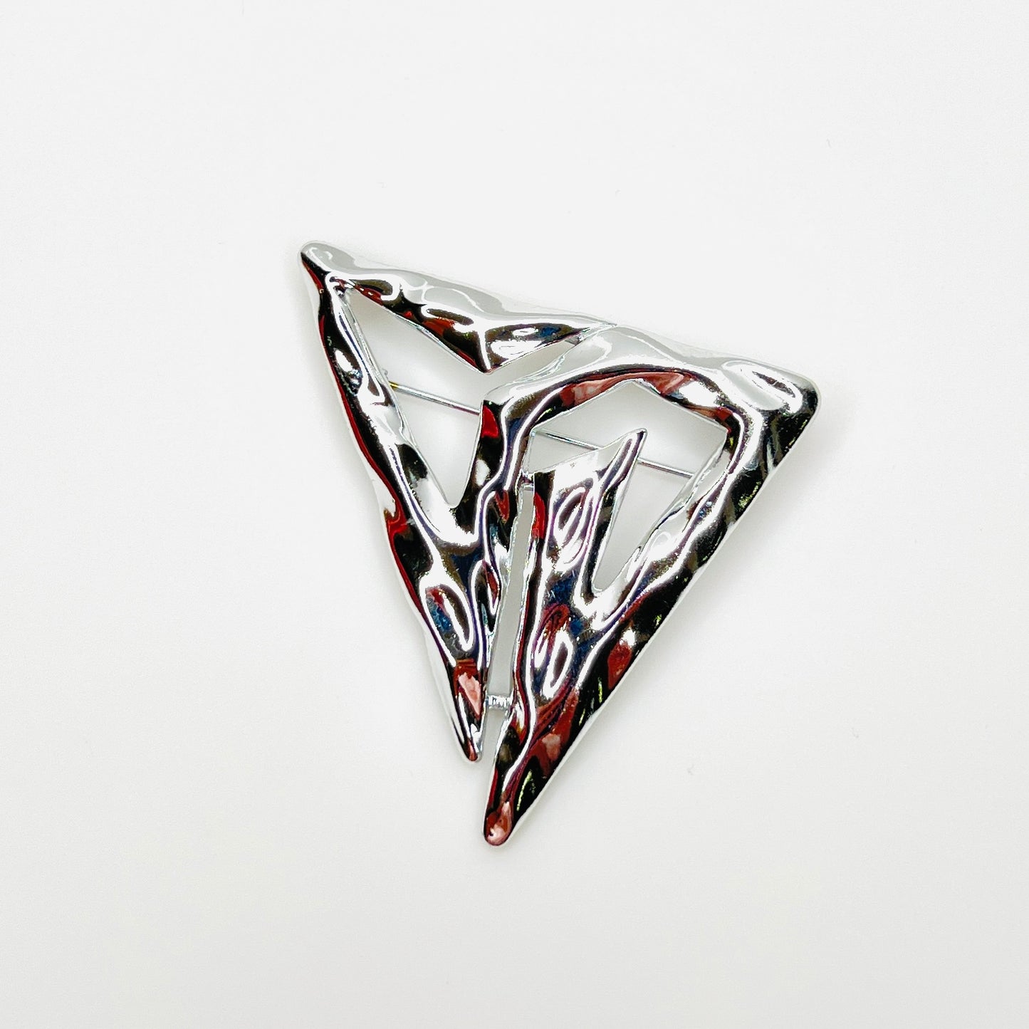 Vintage signed Torino silver-tone abstract Modernist triangle brooch with sculptural openwork design.