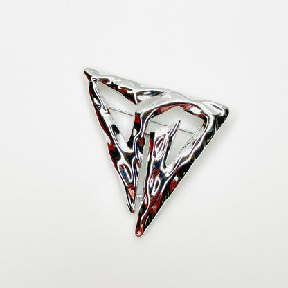 Vintage signed Torino silver-tone abstract Modernist triangle brooch with sculptural openwork design.