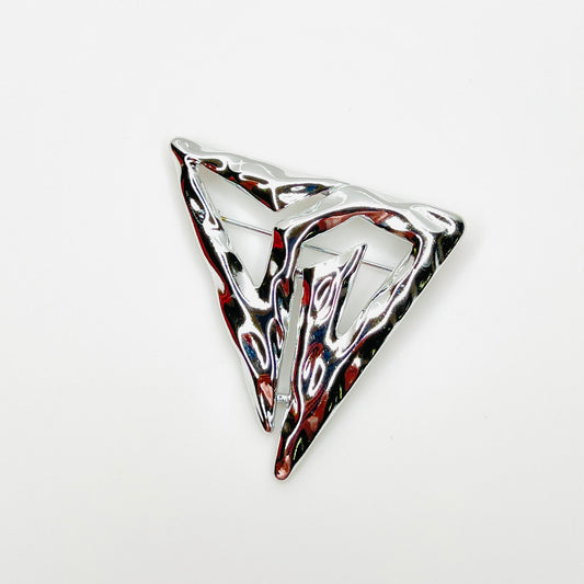 Vintage signed Torino silver-tone abstract Modernist triangle brooch with sculptural openwork design.