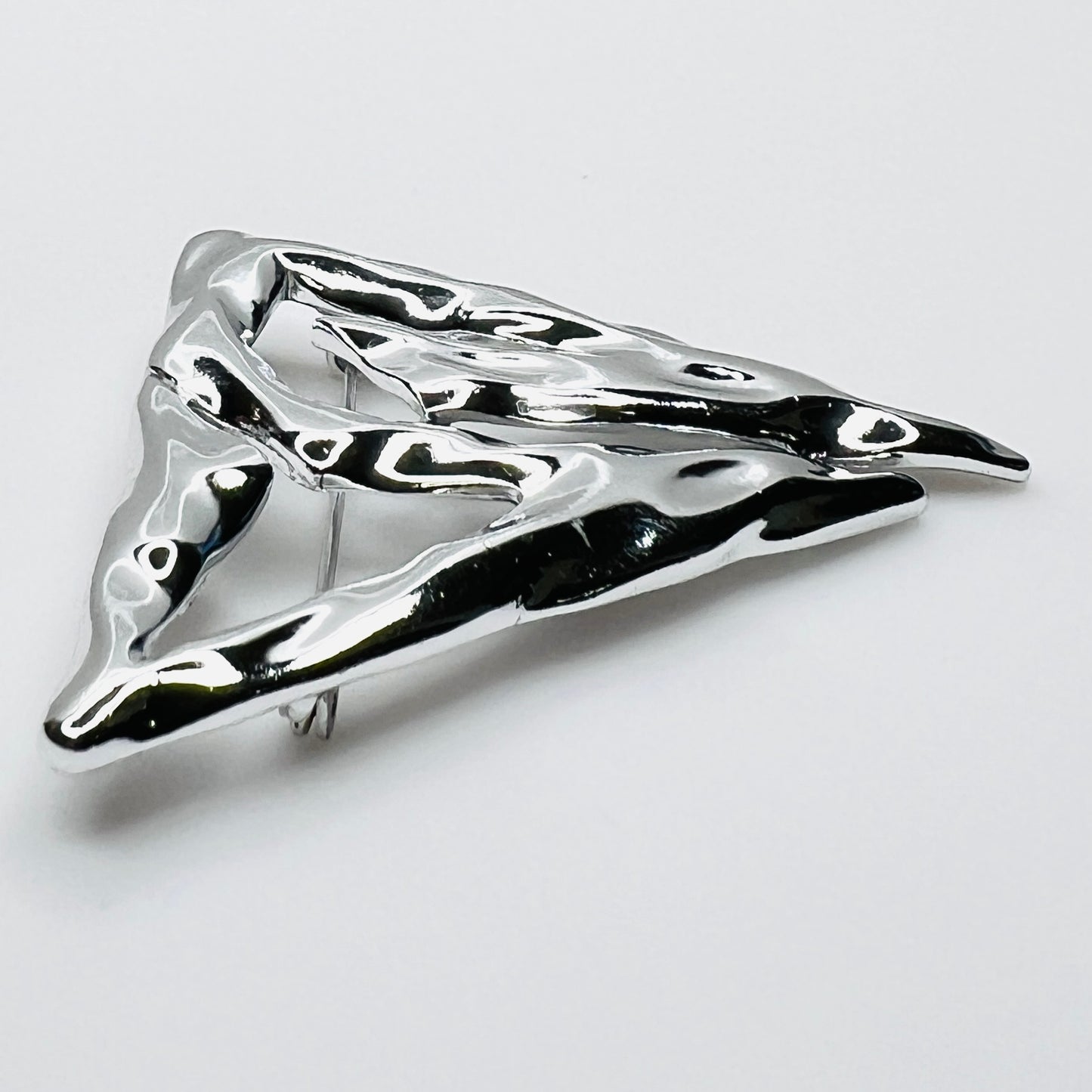 Side profile of vintage Torino abstract geometric brooch showing dimensional sculptural form.