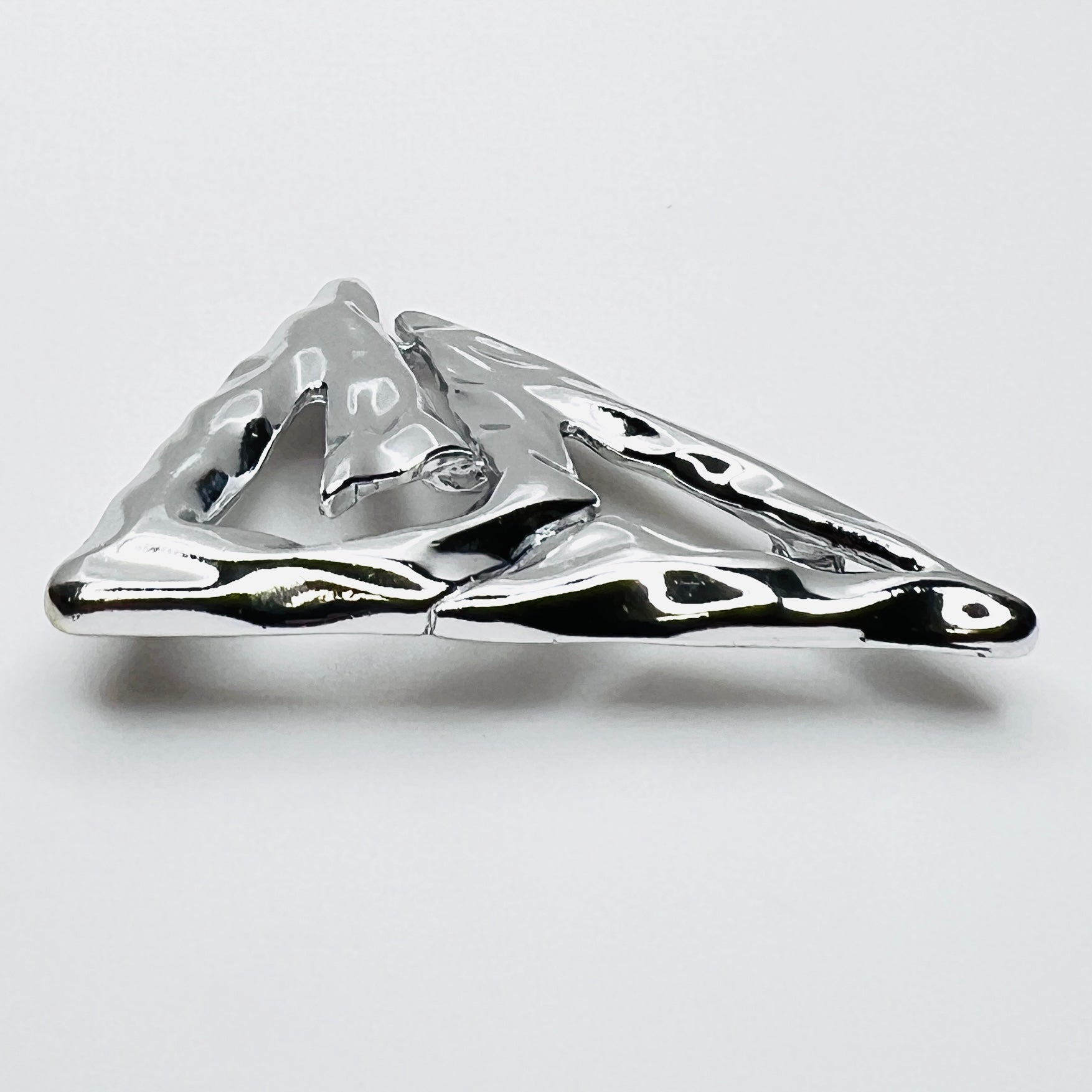 Side profile of vintage Torino abstract geometric brooch showing dimensional sculptural form.
