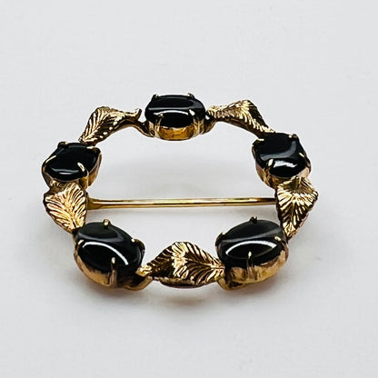 Side view vintage WRE brooch prong set black cabochons gold leaves