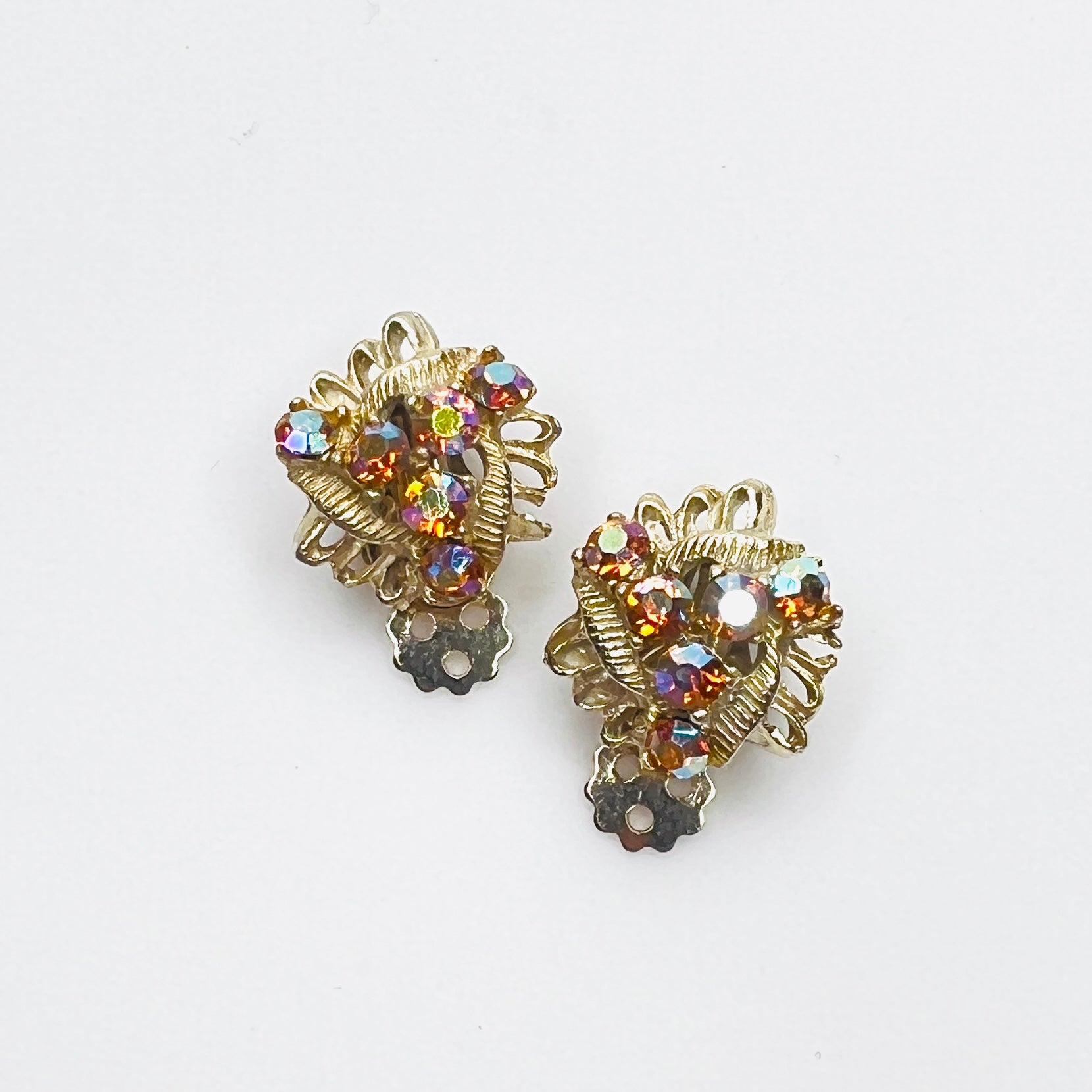 Vintage 1950s amber aurora borealis rhinestone clip-on earrings in gold-tone setting.