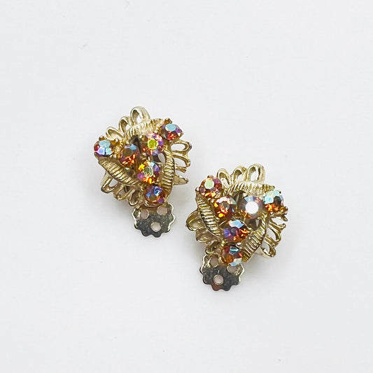 Vintage 1950s amber aurora borealis rhinestone clip-on earrings in gold-tone setting.
