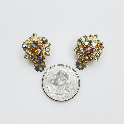 Amber AB rhinestone clip-on earrings with quarter for size comparison.