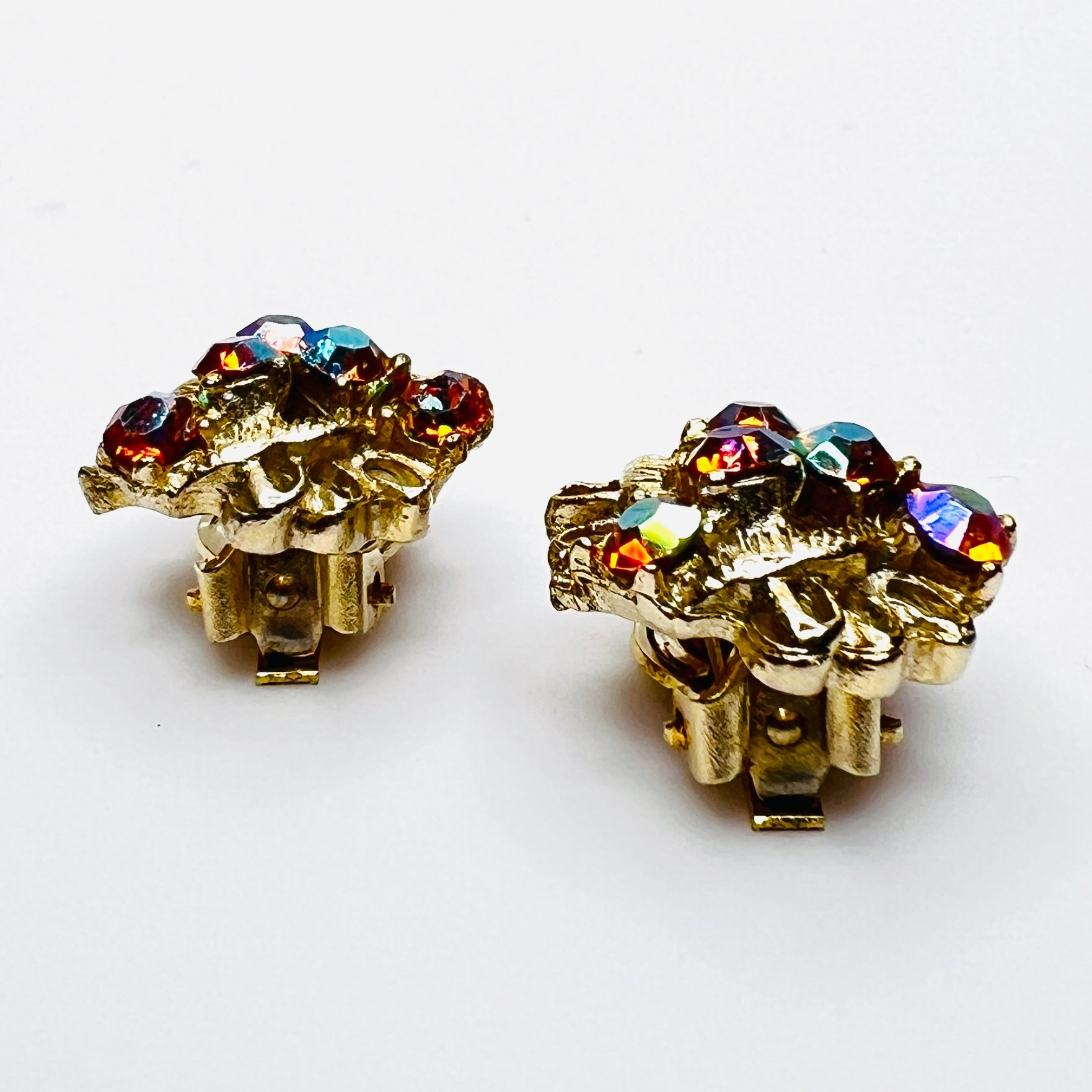 Side profile of vintage gold-tone amber rhinestone clip-on earrings.