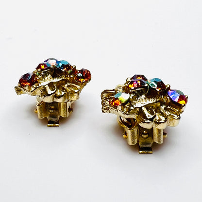 Side profile of vintage gold-tone amber rhinestone clip-on earrings.